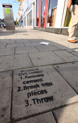 London cement stencil offer advice for civil unrest.